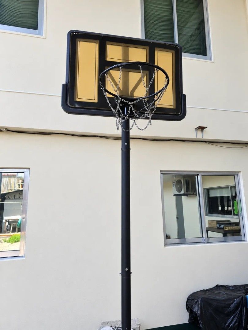 Portable Basketball Hoop System with Chain Net (Category: Racket and Ball Sports) located in Paranaque City. Submitted by cyinquimb (Listing ID 1469649854, Image 2). Description: - Portable outdoor basketball hoop setup ideal for driveways and backyards - Heavy fillable base keeps the stand stable during intense play - Sturdy black pole and rectangular backboard with vibrant yellow panels - Fitted with a heavy-duty metal chain net for longevity -