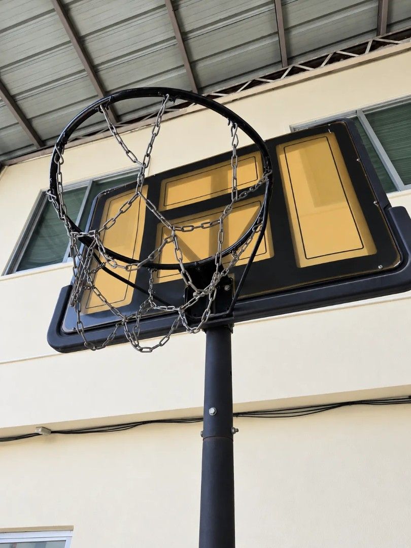 Portable Basketball Hoop System with Chain Net (Category: Racket and Ball Sports) located in Paranaque City. Submitted by cyinquimb (Listing ID 1469649854, Image 1). Description: - Portable outdoor basketball hoop setup ideal for driveways and backyards - Heavy fillable base keeps the stand stable during intense play - Sturdy black pole and rectangular backboard with vibrant yellow panels - Fitted with a heavy-duty metal chain net for longevity -