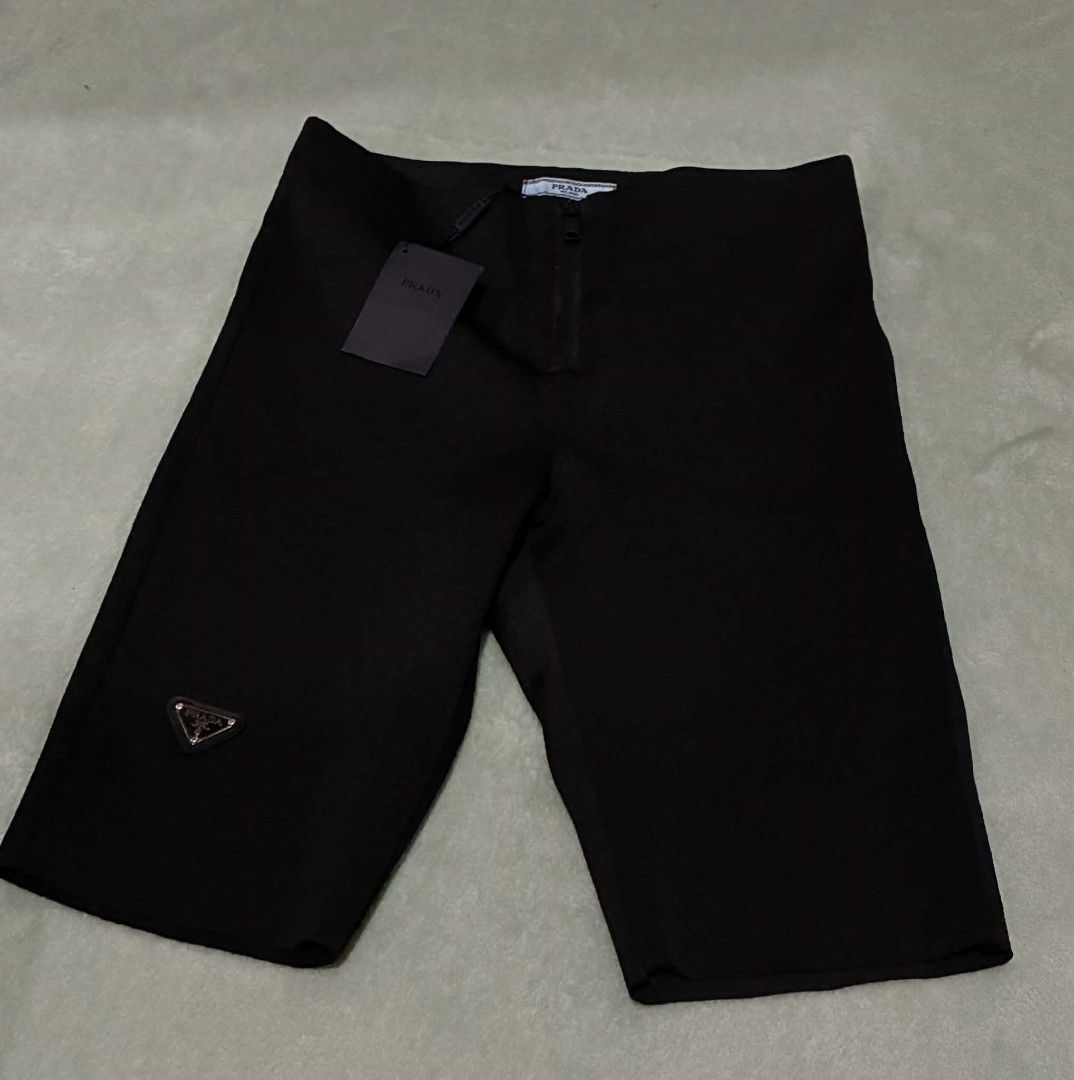 Prada Black Technical Fabric Shorts (Category: Shorts) located in Nabunturan. Submitted by kairosas85 (Listing ID 1469678041, Image 1). Description: - Authentic Prada black shorts - Material: Stretchy technical fabric for ultimate comfort - Fit: Mid-length with an elasticated waistband - Details: Signature enamel triangle logo on the right leg, back pockets - Condition: Brand new with brand tag and care labels attached - Origin: Made in Moldova -