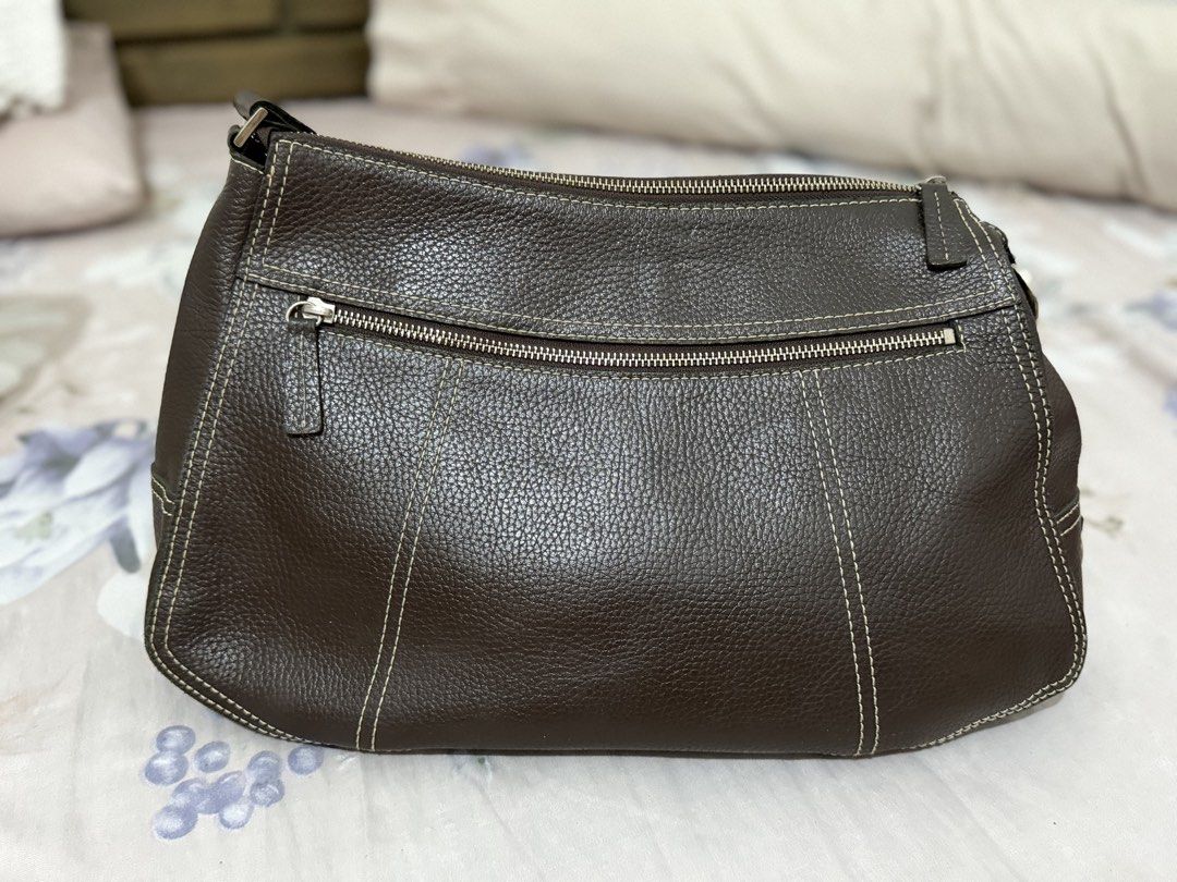 Prada Brown Leather Shoulder Bag (Category: Luxury Bags & Wallets) located in Manila. Submitted by maambeeeeyah (Listing ID 1469676974, Image 3). Description: - Prada shoulder bag in brown pebbled leather - Chic contrast white stitching and embossed front logo - Secure main zippered compartment and exterior back zip pocket - Single adjustable strap with silver-tone hardware and metal clips - Clean bottom and beautifully maintained structured shap