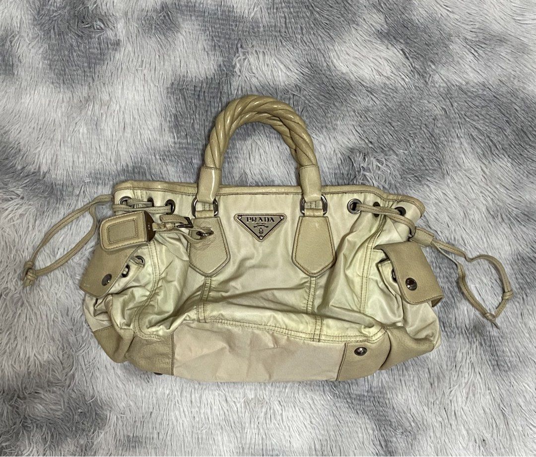 Prada Cream Leather Handbag with Twisted Handles (Category: Luxury Bags & Wallets) located in Tarlac. Submitted by cheap.fleaaa (Listing ID 1469625416, Image 1). Description: Prada✨ No major issues Rank A-B 30,000 + ship Any courier Tarlac based📍.