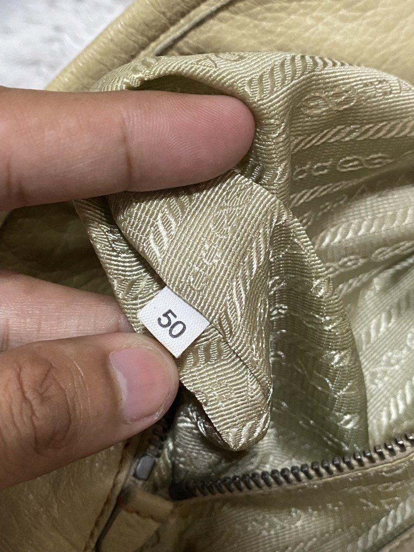 Prada Cream Leather Handbag with Twisted Handles (Category: Luxury Bags & Wallets) located in Tarlac. Submitted by cheap.fleaaa (Listing ID 1469625416, Image 3). Description: Prada✨ No major issues Rank A-B 30,000 + ship Any courier Tarlac based📍.