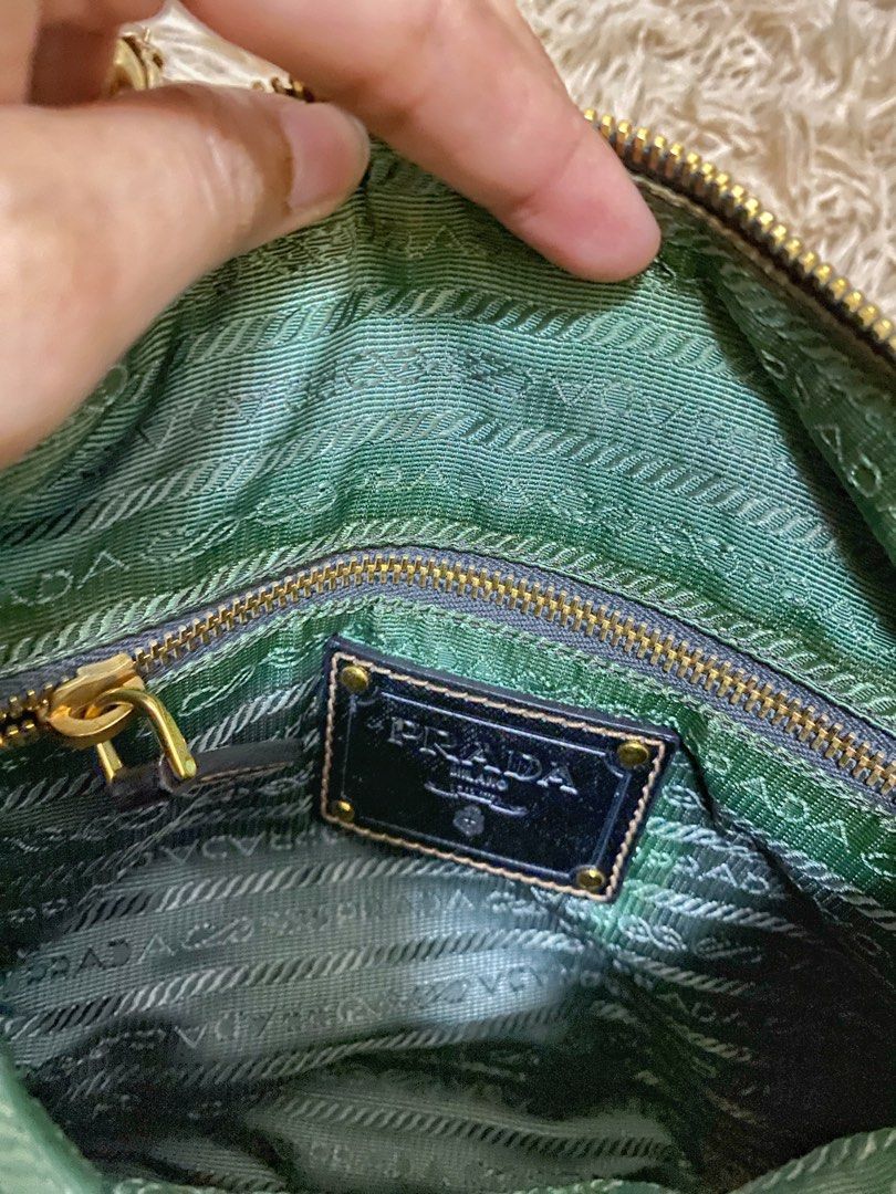 Prada Green Nylon Flap Crossbody Bag (Category: Luxury Bags & Wallets) located in Manila. Submitted by selah_20 (Listing ID 1469680463, Image 3). Description: Details Brand: Prada Milano Color: Green with metallic silver accents Material: Nylon with leather details Hardware: Gold-tone Includes detachable shoulder strap Entrupy Certificate of Authenticity included From UAE Condition: Pre-loved / Vintage The bag has visible discoloration and staini