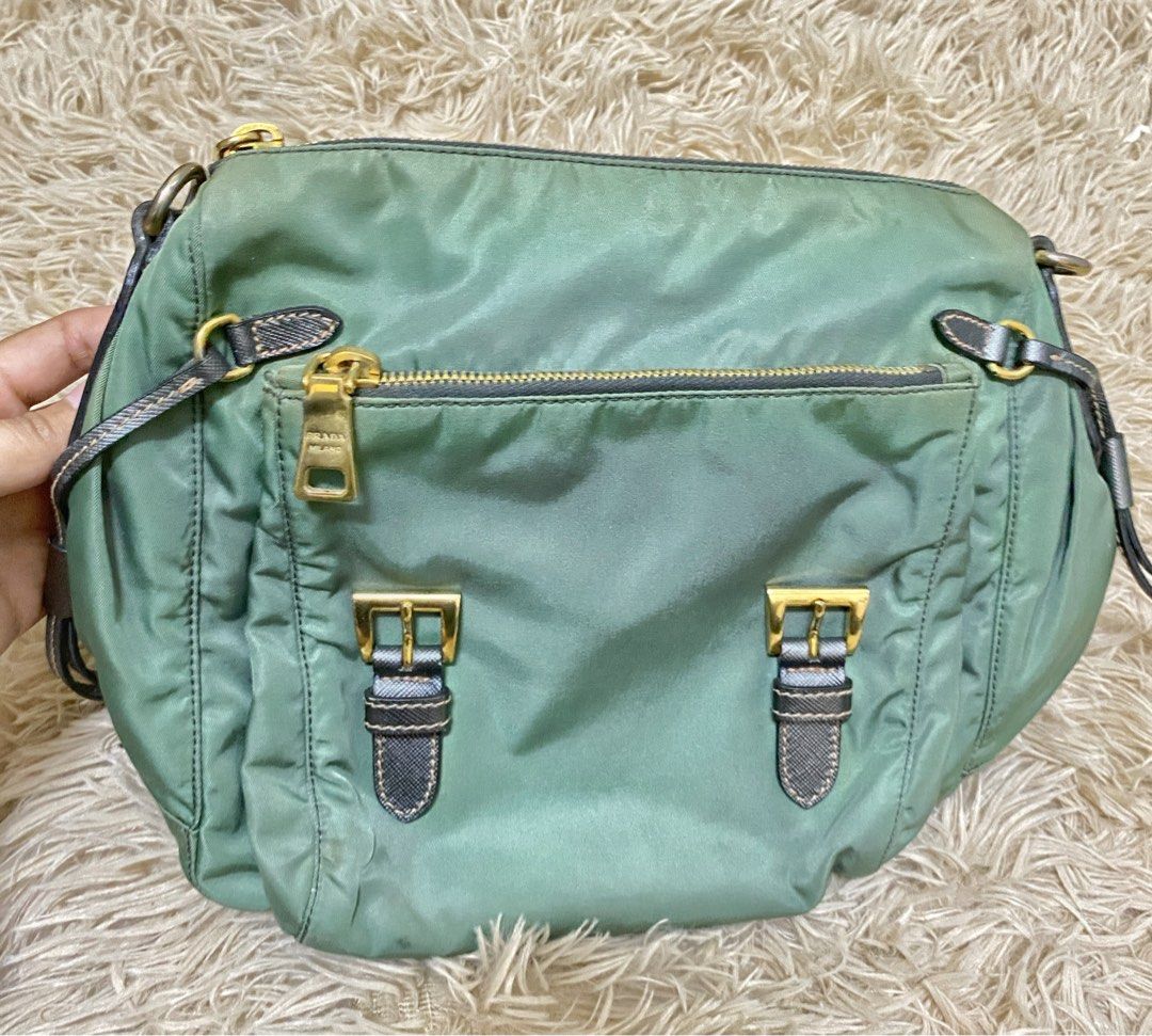 Prada Green Nylon Flap Crossbody Bag (Category: Luxury Bags & Wallets) located in Manila. Submitted by selah_20 (Listing ID 1469680463, Image 2). Description: Details Brand: Prada Milano Color: Green with metallic silver accents Material: Nylon with leather details Hardware: Gold-tone Includes detachable shoulder strap Entrupy Certificate of Authenticity included From UAE Condition: Pre-loved / Vintage The bag has visible discoloration and staini
