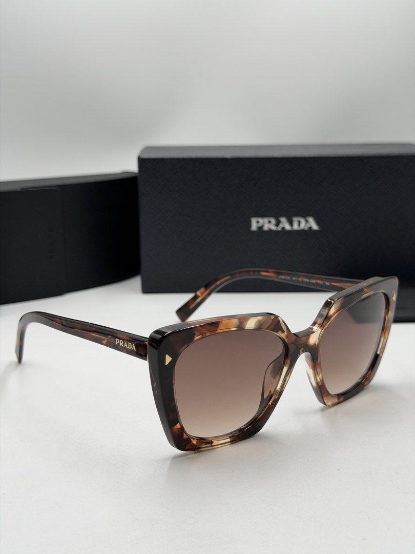 Prada PR 23ZS Sunglasses (Category: Luxury Accessories) located in Lipa City. Submitted by _cmluxephilippines (Listing ID 1469671344, Image 1). Description: Prada PR 23ZS Sunglasses Prada PR 23ZS Sunglasses. This design highlights an angular, multi-faceted square acetate frame in a caramel tortoiseshell pattern, paired with thin temples carrying the classic signature logo • Brand: Prada • Model: PR 23ZS (also referenced as SPR 23Z) • Color Code: 