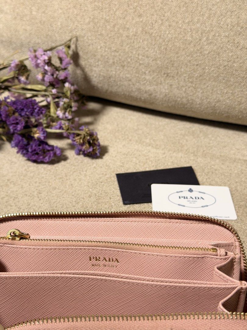 Prada Saffiano Leather Bow Zip Around Wallet Pink (Category: Purses & Pouches) located in Manila. Submitted by monicagellerbing__ (Listing ID 1469686003, Image 3). Description: Authentic Prada Saffiano Fiocco Wallet Orchidea - Authentic Prada Saffiano leather wallet in a charming soft pink shade - Secure zip-around closure with elegant gold-tone hardware - Features an adorable bow detail paired with the iconic Prada logo plaque - Well-organized i