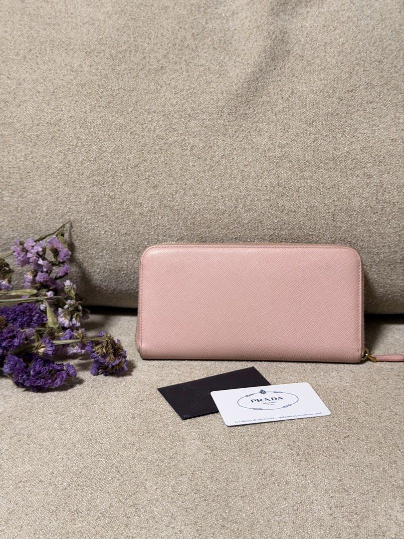 Prada Saffiano Leather Bow Zip Around Wallet Pink (Category: Purses & Pouches) located in Manila. Submitted by monicagellerbing__ (Listing ID 1469686003, Image 2). Description: Authentic Prada Saffiano Fiocco Wallet Orchidea - Authentic Prada Saffiano leather wallet in a charming soft pink shade - Secure zip-around closure with elegant gold-tone hardware - Features an adorable bow detail paired with the iconic Prada logo plaque - Well-organized i