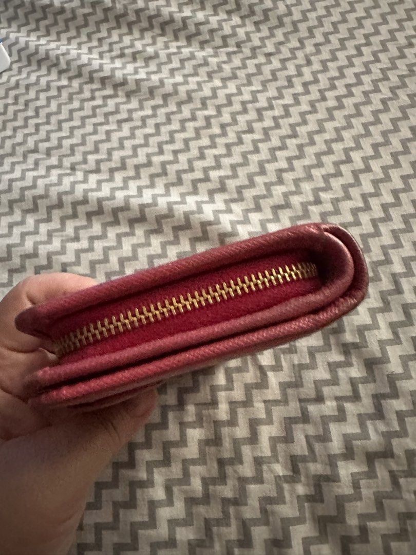 Prada Saffiano Leather Pink Wallet (Category: Luxury Bags & Wallets) located in Antipolo. Submitted by prelovedcloseta (Listing ID 1469608757, Image 3). Description: - Authentic Prada wallet in gorgeous pink Saffiano leather - Iconic gold-tone Prada Milano logo plaque on the front - Secure snap button closure strap on the back - Interior includes multiple card slots and convenient slip compartments - Side zip compartment for coins - Condition: Sh