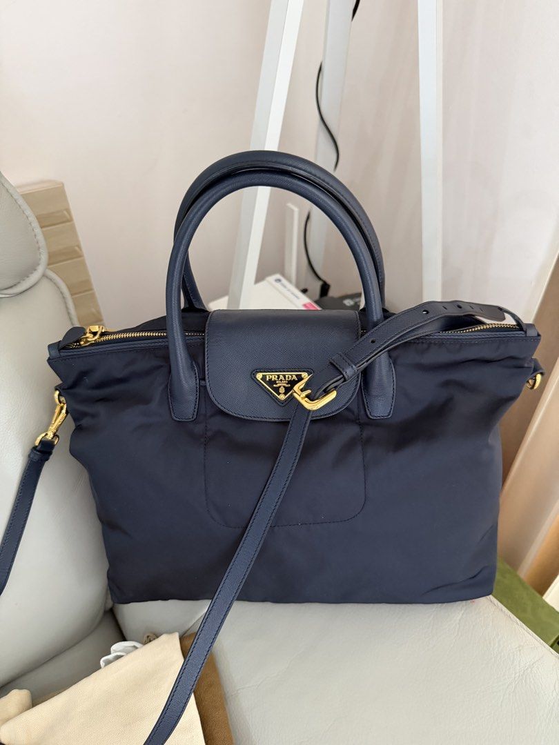 Prada Tessuto Nylon- Navy Blue (Category: Cross-body Bags) located in Makati City. Submitted by lambogirl (Listing ID 1469622050, Image 2). Description: ✔️comes with strap, dust bag and entrupy ✔️in excellent condition ✔️free shipping or pick up (Makati).