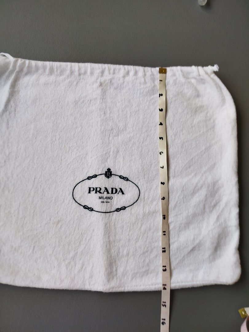 Prada White Dust Bag (Category: Luxury Bags & Wallets) located in Calamba. Submitted by merrymerida (Listing ID 1469634490, Image 2). Description: - 100% Authentic white Prada dust bag - Features the iconic black Prada Milano logo in the center - Soft and clean white cotton material - Secure drawstring closure at the top - Approximate dimensions: 17" width x 15" length - Ideal for safe storage of luxury handbags and accessories - From a trusted t