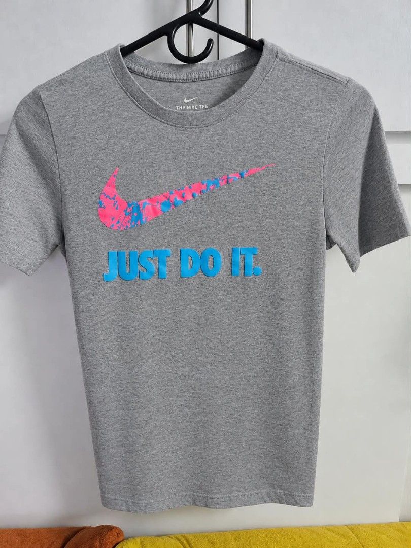 PRELOVED - Authentic Nike Tees (KIDS) (Category: Tshirts & Polo Shirts ) located in Manila. Submitted by khel.trinidad (Listing ID 1469672284, Image 3). Description: - Bundle of 4 authentic Nike short-sleeve tees for casual wear or training - Black tee with fun soccer monster graphic - White tee featuring classic red Nike block logo and soccer ball - Heather grey tee with pink/blue splatter swoosh and blue "Just Do It" text - Heather blue athleti