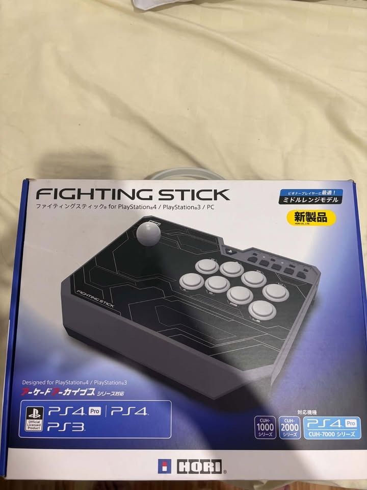PS4 Hori Fighting Stick For (PS4-129A) (Category: Controllers) located in Binan City. Submitted by safe_gorpfriday (Listing ID 1469721496, Image 2). Description: Hori Fighting Stick with Receipt NEGOTIABLE!!! - Comes complete with the original box - Standard arcade layout featuring a responsive joystick and eight action buttons - Stylish black finish with grey accents and a clean white ball top - Tested and working great, ready to use Issue: Sunk