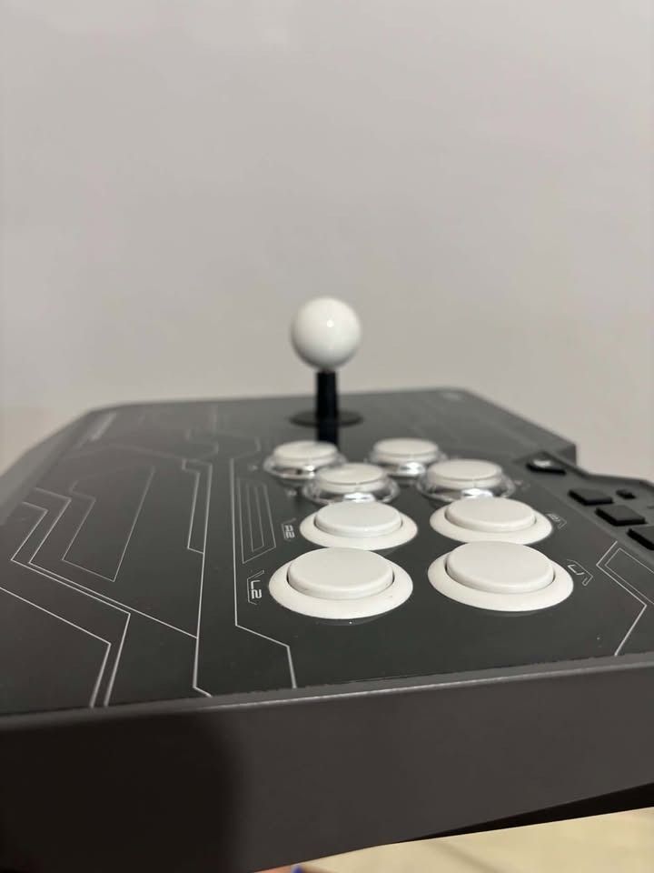 PS4 Hori Fighting Stick For (PS4-129A) (Category: Controllers) located in Binan City. Submitted by safe_gorpfriday (Listing ID 1469721496, Image 3). Description: Hori Fighting Stick with Receipt NEGOTIABLE!!! - Comes complete with the original box - Standard arcade layout featuring a responsive joystick and eight action buttons - Stylish black finish with grey accents and a clean white ball top - Tested and working great, ready to use Issue: Sunk
