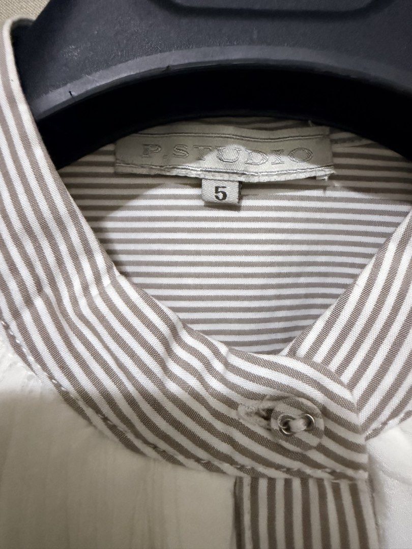 p.studio Striped Shirt with White Ruffle Collar Size 5 (Category: Blouses) located in Cavite. Submitted by mgd.blessed (Listing ID 1469647227, Image 2). Description: - Brand/Model: P.Studio button-down shirt - Color/Pattern: Beige and white stripes - Key Features: Stand-up collar with a large, dramatic white pleated ruffle bib, mid-length sleeves, and front button closure - Size: 5 - Condition: Clean, well-maintained, and ready to wear.