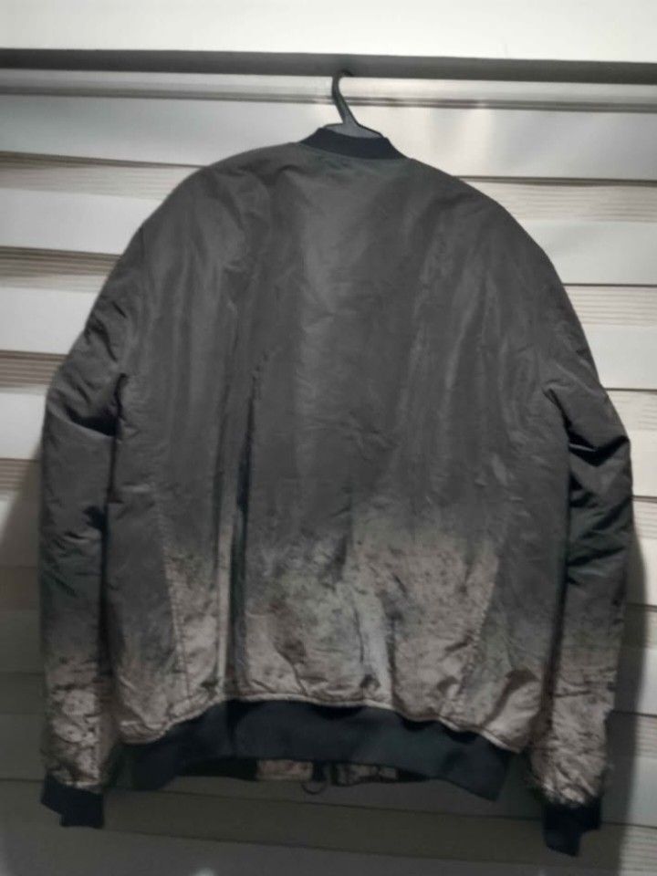 Pull&Bear STWD Bomber Jacket (Category: Coats, Jackets and Outerwear) located in Antipolo. Submitted by sagarom (Listing ID 1469696703, Image 3). Description: - Brand/Model: Pull&Bear STWD Bomber Jacket - Color: Grey and black with heavy acid wash gradient effect - Size: L (Comfortable fit) - Interior: Bright orange inner lining - Details: Full zip front, ribbed collar/cuffs/hem, utility pocket on left sleeve, and chest patch - Origin: Made in Ba
