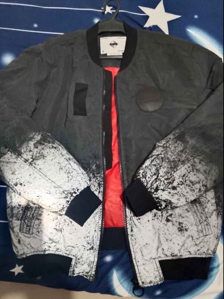 Pull&Bear STWD Bomber Jacket (Category: Coats, Jackets and Outerwear) located in Antipolo. Submitted by sagarom (Listing ID 1469696703, Image 2). Description: - Brand/Model: Pull&Bear STWD Bomber Jacket - Color: Grey and black with heavy acid wash gradient effect - Size: L (Comfortable fit) - Interior: Bright orange inner lining - Details: Full zip front, ribbed collar/cuffs/hem, utility pocket on left sleeve, and chest patch - Origin: Made in Ba