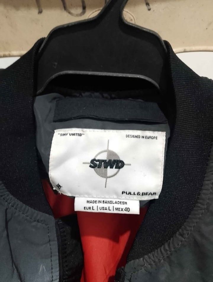 Pull&Bear STWD Bomber Jacket (Category: Coats, Jackets and Outerwear) located in Antipolo. Submitted by sagarom (Listing ID 1469696703, Image 1). Description: - Brand/Model: Pull&Bear STWD Bomber Jacket - Color: Grey and black with heavy acid wash gradient effect - Size: L (Comfortable fit) - Interior: Bright orange inner lining - Details: Full zip front, ribbed collar/cuffs/hem, utility pocket on left sleeve, and chest patch - Origin: Made in Ba