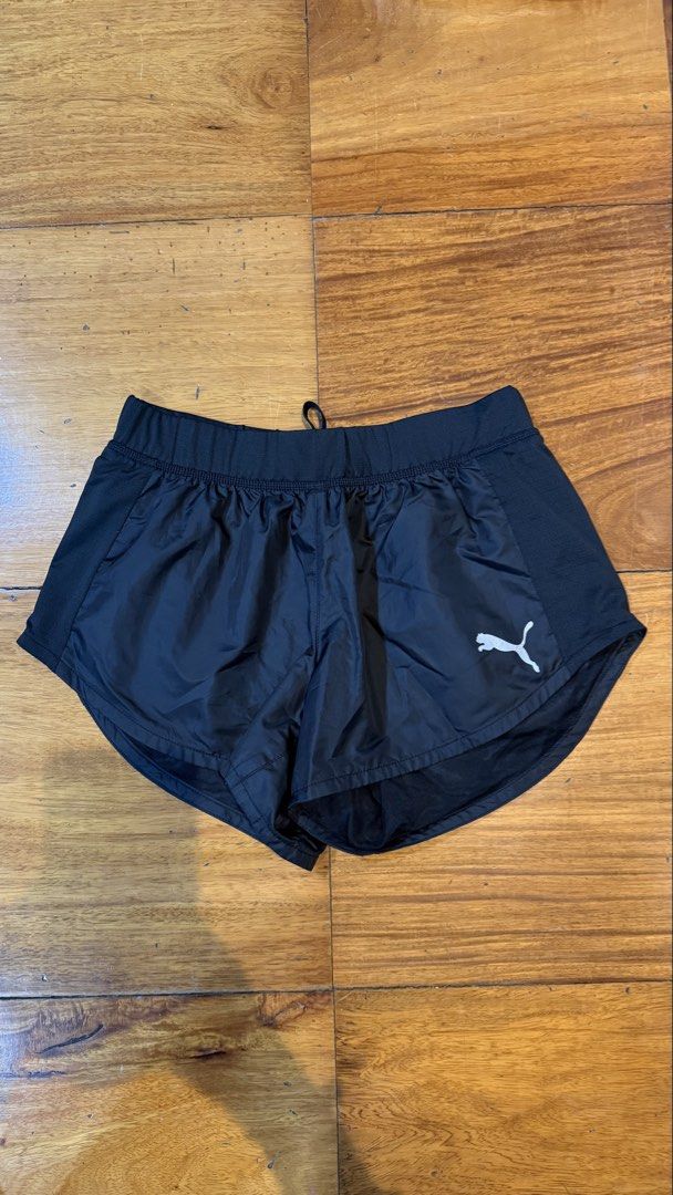 Puma Black Athletic Running Shorts (Category: Activewear) located in Makati City. Submitted by thevault88 (Listing ID 1469697564, Image 2). Description: - Brand/Model: Puma Running Shorts - Color: Classic black - Fit: Elastic waistband with adjustable inner drawstring - Material: Lightweight performance fabric - Ventilation: Breathable side mesh panels - Condition: Clean interior lining, well-maintained - Best for: Running, gym sessions, and gene