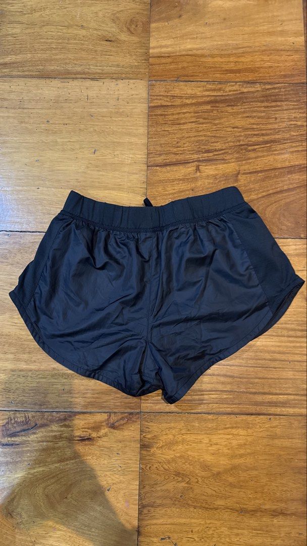 Puma Black Athletic Running Shorts (Category: Activewear) located in Makati City. Submitted by thevault88 (Listing ID 1469697564, Image 3). Description: - Brand/Model: Puma Running Shorts - Color: Classic black - Fit: Elastic waistband with adjustable inner drawstring - Material: Lightweight performance fabric - Ventilation: Breathable side mesh panels - Condition: Clean interior lining, well-maintained - Best for: Running, gym sessions, and gene