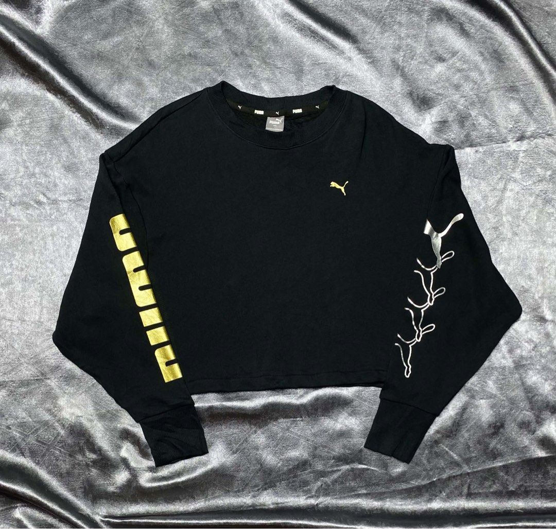 Puma Black Crop Sweatshirt Size L (Category: Coats, Jackets and Outerwear) located in Cavite. Submitted by bellewii (Listing ID 1469681364, Image 1). Description: - Brand: Puma (Style No. 582804-51, Made in China) - Size: Asian L (Cropped fit) - Color: Black with metallic prints - Details: Large gold Puma lettering on right sleeve, four silver leaping cats on left sleeve, and embroidered gold jumping cat logo on chest - Features: Ribbed crew neck