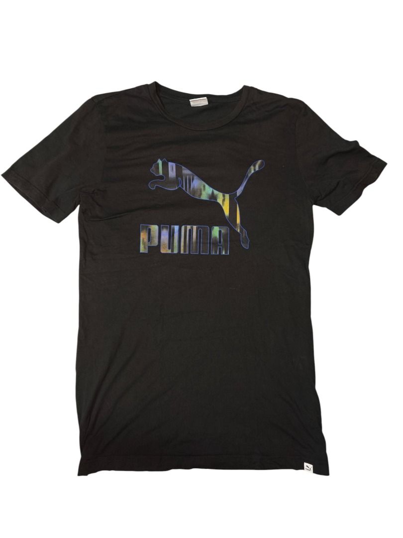 Puma Black Iridescent Logo Tee (Category: Tshirts & Polo Shirts ) located in Baguio. Submitted by boneteezandharmony (Listing ID 1469664463, Image 1). Description: Black Puma tee featuring a large iridescent Cat logo and PUMA lettering with a multicolor reflective effect. A simple athletic staple with a standout graphic. Condition: 9/10 Size on tag: M Dimes: Approx. 19W × 30L.