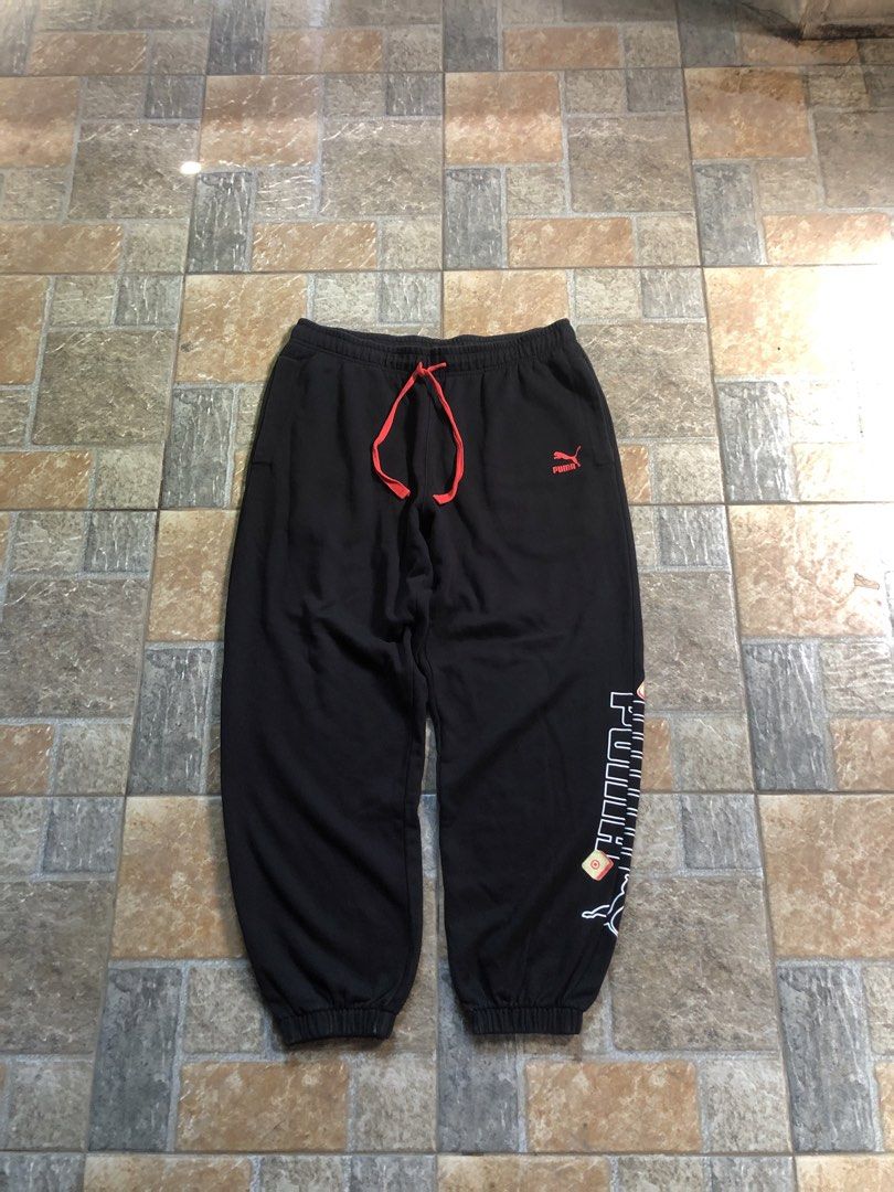 Puma Black Sweatpants Joggers with Red Drawstring (Category: Joggers) located in San Pablo. Submitted by jilescalla (Listing ID 1469675142, Image 1). Description: - Color: Black with bright red and white accents - Material: Soft and comfortable fabric, perfect for casual wear - Waistband: Elastic with a bright red adjustable drawstring - Logos: Small red Puma logo on upper left leg - Details: Large white vertical Puma text and outline logo near t