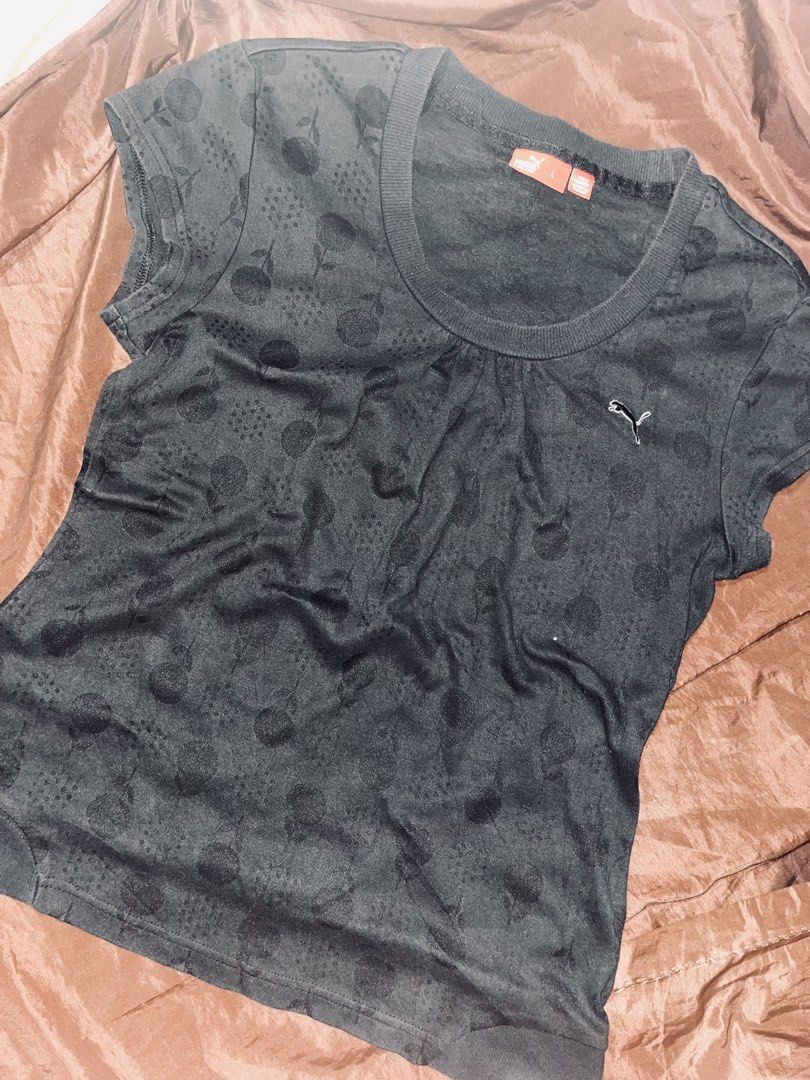 Puma Black T-Shirt with Pattern Size L (Category: Shirts) located in Dagupan City. Submitted by shanadongsb (Listing ID 1469724646, Image 1). Description: - Brand: Puma - Style: Crew neck top - Color: Black with subtle all-over polka dot and circular pattern - Size: Large (L) - Details: Small embroidered Puma cat logo on left chest, ribbed collar and cuffs - Condition: Great for casual, everyday wear - Mode of Payment: GCash, bank transfer, or CO