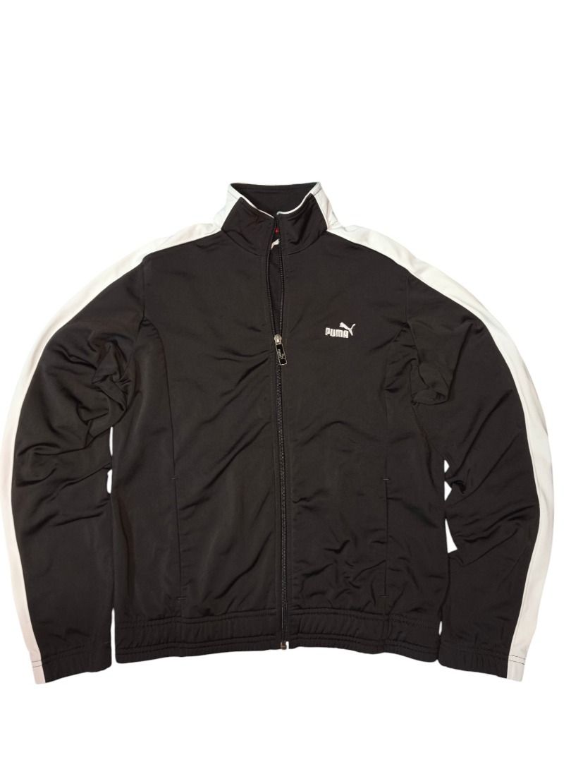 PUMA TRACK JACKET (Category: Coats, Jackets and Outerwear) located in Baguio. Submitted by boneteezandharmony (Listing ID 1469665137, Image 1). Description: Black Puma zip-up with white contrast sleeve panels and a clean chest logo. Easy everyday sportswear staple. Condition: Very Good Size on tag: M Dimes: Approx. 19” width × 23” length.