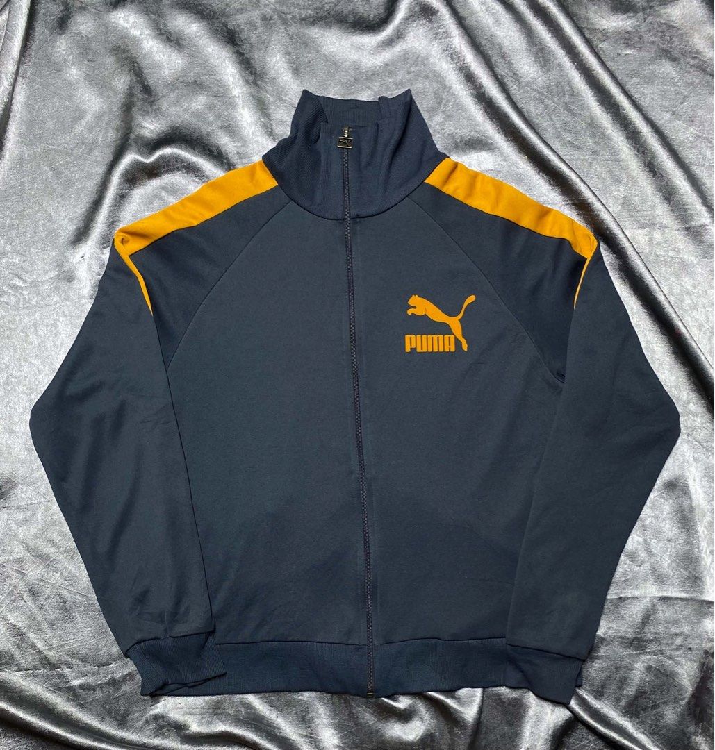 Puma Track Jacket Navy Blue Orange XXL (Category: Coats, Jackets and Outerwear) located in Cavite. Submitted by bellewii (Listing ID 1469680461, Image 1). Description: - Brand: Puma - Color: Navy blue with bright orange stripes and logo - Size: XXL (red neck tag) - Features: High stand-up collar, full zip front with branded metal pull tab - Origin: Made in Cambodia - Condition: Excellent pre-loved condition.