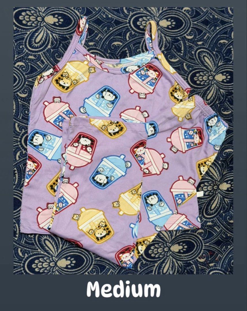 Purple Bubble Tea Cartoon Print Pajama Set Medium (Category: Sets or Coordinates) located in Pasig City. Submitted by revieconde (Listing ID 1469754339, Image 1). Description: - Item: Purple pajama set (spaghetti strap top and matching shorts) - Print: Cute bubble tea cups with little animals - Size: Medium - Condition: Brand new, never worn, clean - Material: Soft and comfortable for sleeping or lounging.