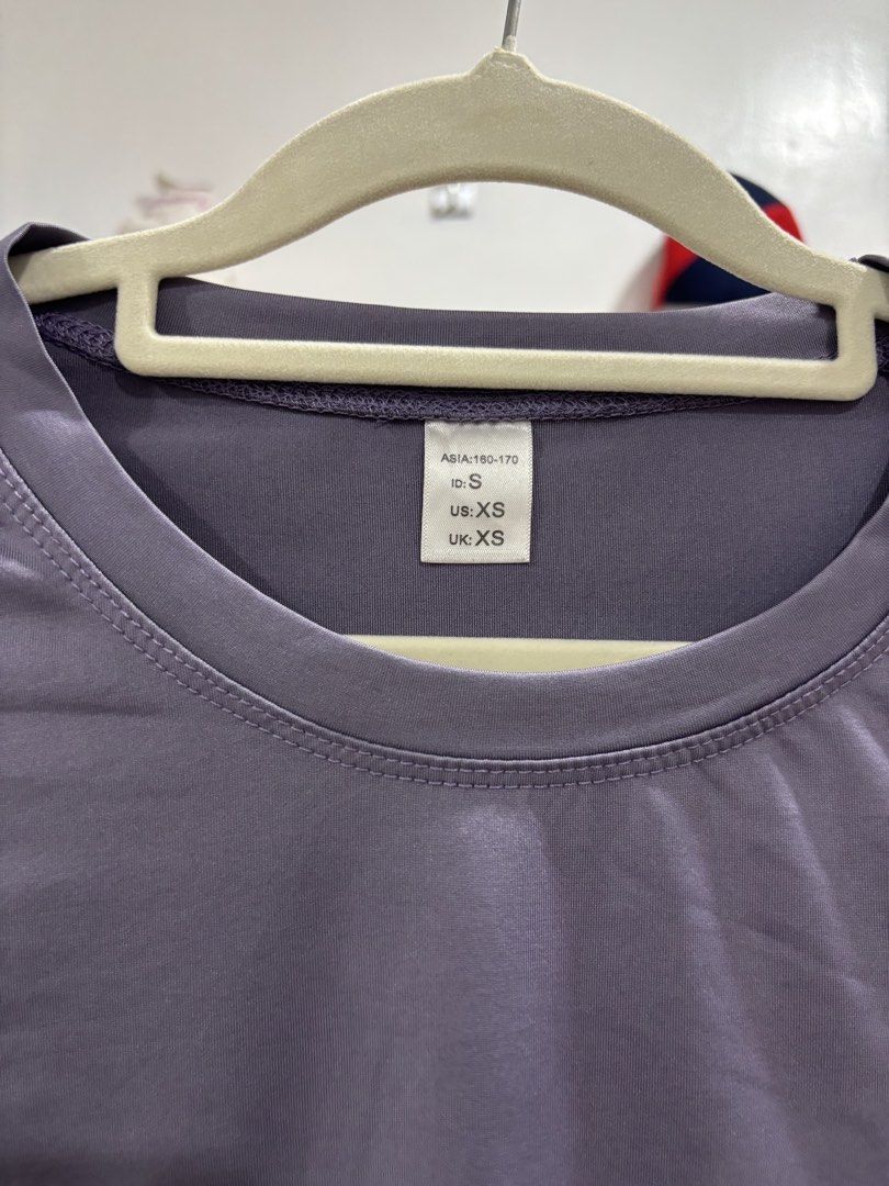 Purple Crop Top Short Sleeve Tee (Category: Shirts) located in Calbayog City. Submitted by zaxcheus_castillo1708 (Listing ID 1469672940, Image 2). Description: - Color: Solid Purple - Style: Short sleeve crop top with round crew neckline - Material: Smooth, comfortable athletic fabric - Size: US/UK XS, Asia 160-170 (ID: S) - Versatile: Great for casual wear or workouts, easy to match with high-waisted jeans or shorts - Condition: Clean and well-m