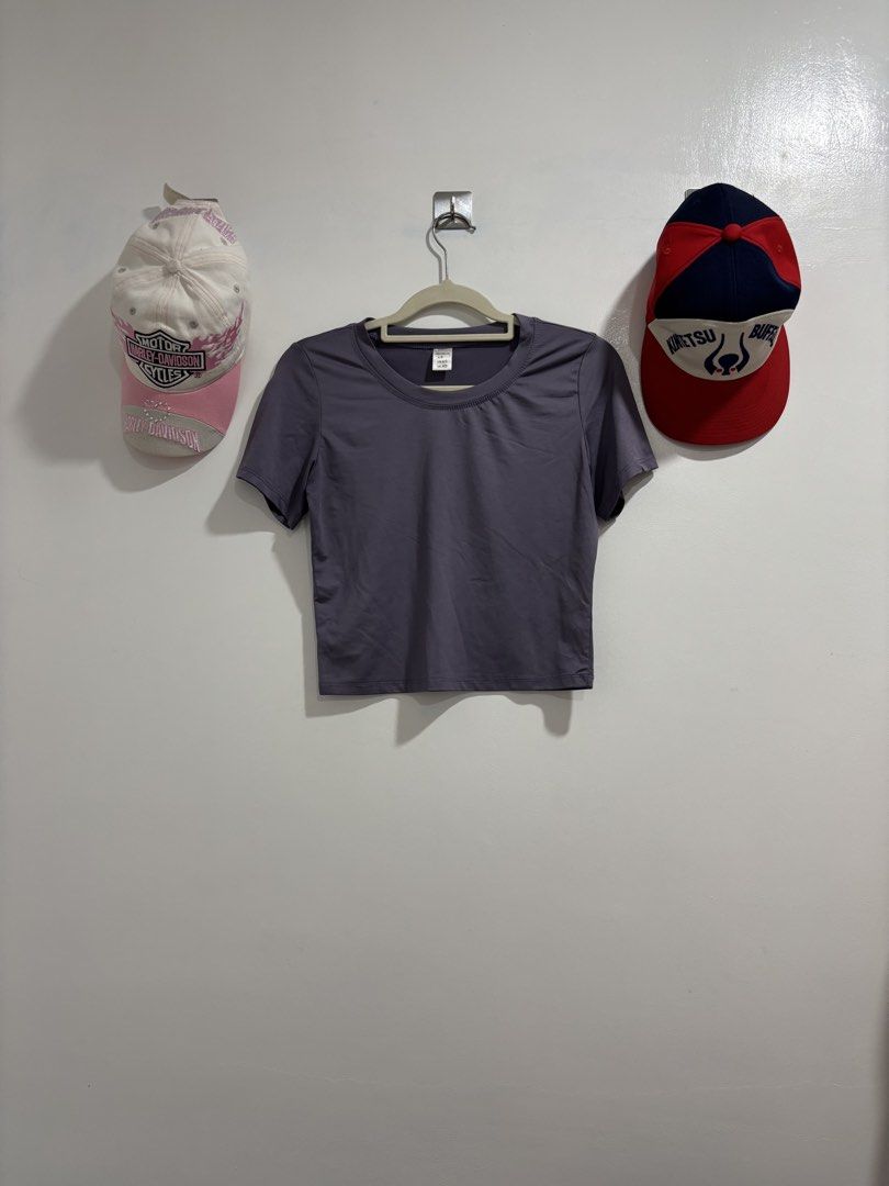 Purple Crop Top Short Sleeve Tee (Category: Shirts) located in Calbayog City. Submitted by zaxcheus_castillo1708 (Listing ID 1469672940, Image 1). Description: - Color: Solid Purple - Style: Short sleeve crop top with round crew neckline - Material: Smooth, comfortable athletic fabric - Size: US/UK XS, Asia 160-170 (ID: S) - Versatile: Great for casual wear or workouts, easy to match with high-waisted jeans or shorts - Condition: Clean and well-m