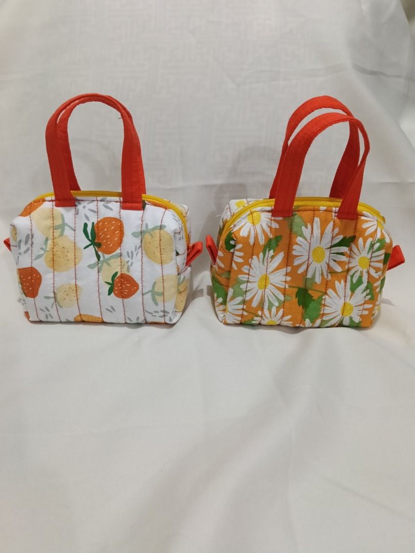 Quilted Mini Pouch with handle (Category: Purses & Pouches) located in Caloocan City. Submitted by wisedolphin_d6fc90 (Listing ID 1469630223, Image 2). Description: - Mini quilted pouches with top handle and zipper closure - Soft, padded fabric with structured stitching - Compact size fits daily essentials like lipstick, compact powder, or small digital cameras - Available designs: Printed Design - Handmade and ready to ship - Mode of payment: GC