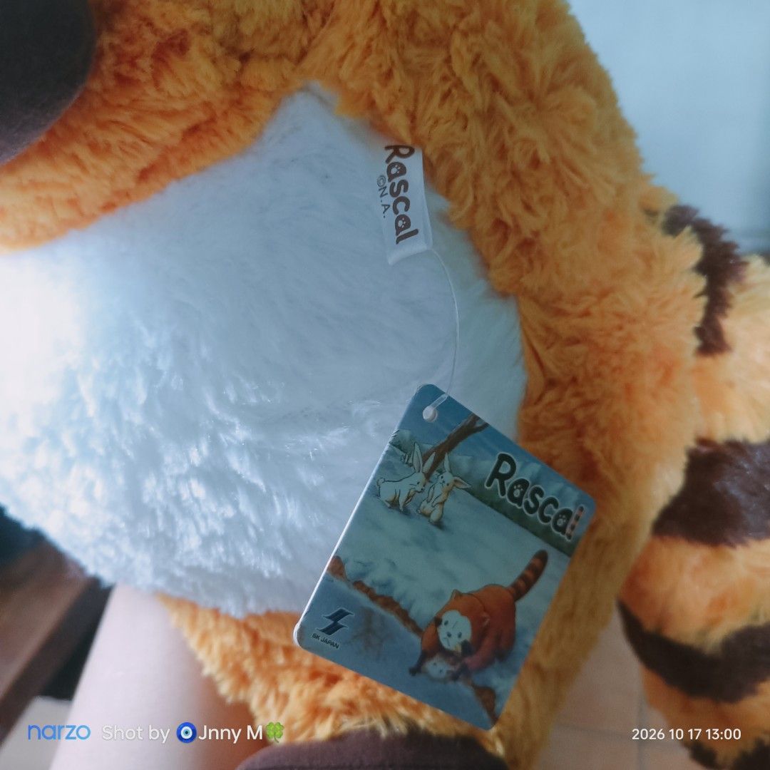 Rascal the Raccoon Plush Toy with Tags (Category: Plushies & Soft Toys) located in Taguig. Submitted by mhayestufftoys (Listing ID 1469589484, Image 2). Description: - Official Rascal N.A. merchandise made by BK Japan - Fluffy orange and white fur with a cute brown striped tail - Embroidered facial details for a high-quality finish - Comes with original hang tag and tush tag attached.