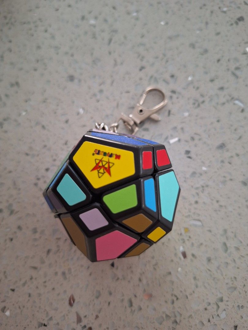 Recent Toys Mini Skewb Keychain Puzzle Cube (Category: Board Games & Puzzles) located in Batangas. Submitted by tins_closet88 (Listing ID 1469579939, Image 1). Description: - Item: Mini Skewb Twist Puzzle Cube Keychain - Design: Vibrant multi-colour tiles with a classic black frame - Features: Fully functional mini puzzle, compact size with a sturdy keychain attachment - Condition: Brand new in original box inside a protective clear plastic case 