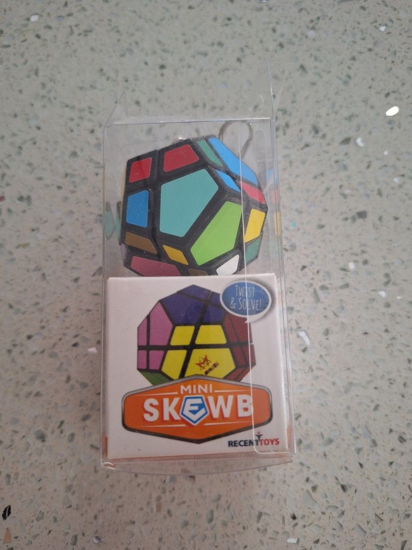 Recent Toys Mini Skewb Keychain Puzzle Cube (Category: Board Games & Puzzles) located in Batangas. Submitted by tins_closet88 (Listing ID 1469579939, Image 2). Description: - Item: Mini Skewb Twist Puzzle Cube Keychain - Design: Vibrant multi-colour tiles with a classic black frame - Features: Fully functional mini puzzle, compact size with a sturdy keychain attachment - Condition: Brand new in original box inside a protective clear plastic case 