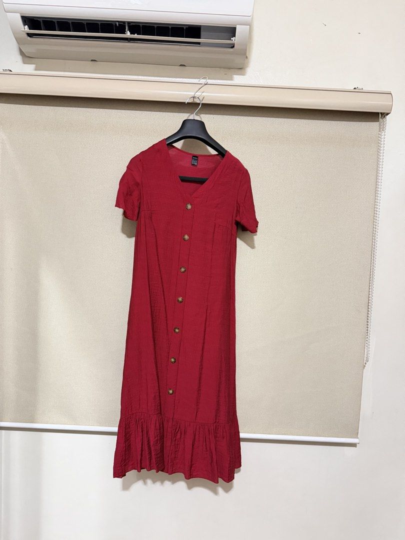Red button-down midi dress with ruffle hem (Category: Dresses) located in Cavite. Submitted by mgd.blessed (Listing ID 1469634236, Image 2). Description: - Color: Red - Style: Casual midi dress with V-neckline and short sleeves - Details: Functional front button row and playful gathered ruffle hem - Fabric: Lightweight and breathable with a textured finish - Perfect for: Daily wear, weekend getaways, and casual dates - Condition: Brand new / Exce