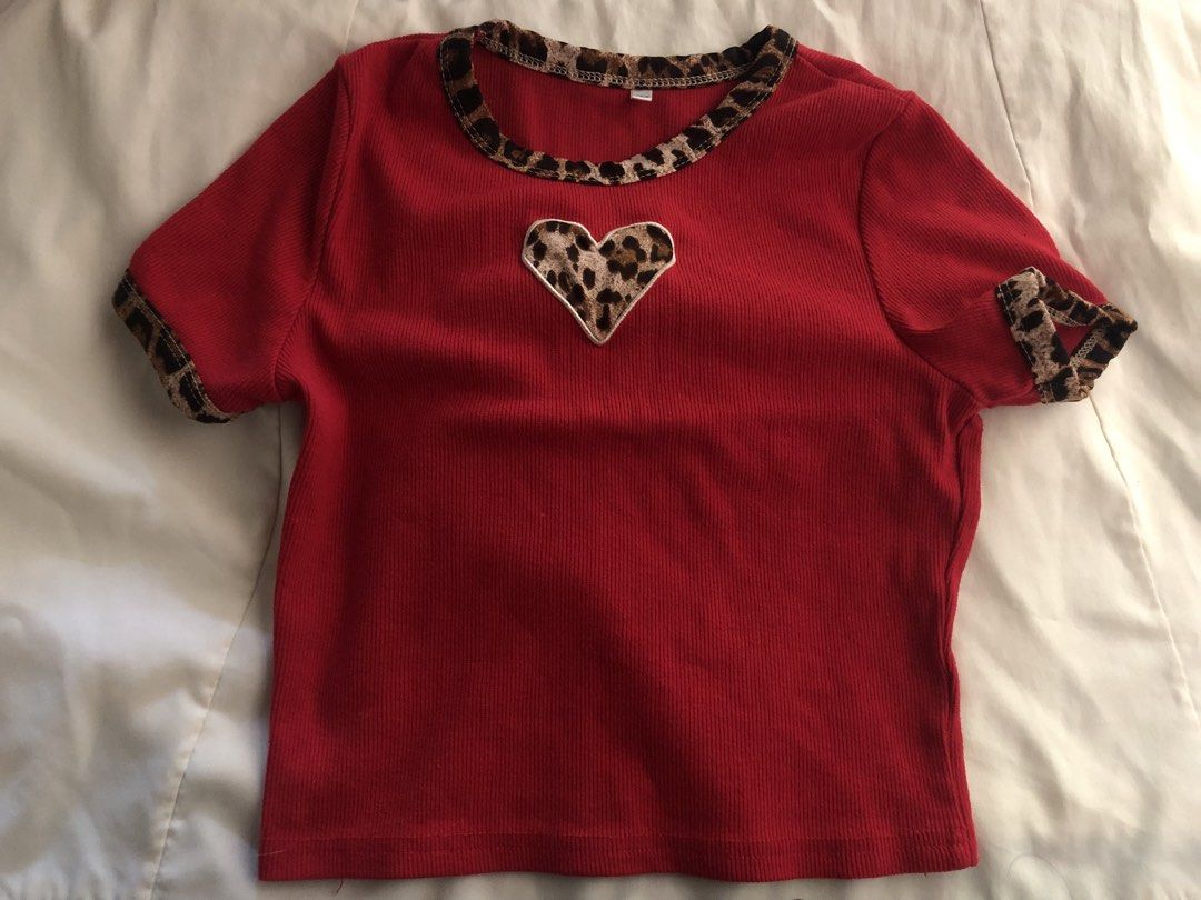 Red Ribbed Crop Top with Leopard Trim and Heart Patch (Category: Shirts) located in Manila. Submitted by seethestarrz (Listing ID 1469713855, Image 1). Description: - Color: Bright red with leopard print trim - Design: Ribbed fabric, leopard print collar and cuffs, matching heart patch on chest - Fit: Short sleeves, stretchy and flattering crop top 📍qc, metro manila 🚚 jnt, sf shouldered by buyer dm for more details!!.