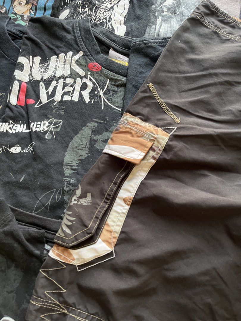 Redsand Brown Camo Cargo Board Shorts (Category: Shorts) located in Baao. Submitted by plainclothesdept (Listing ID 1469696910, Image 3). Description: y2k redsand boardshorts waist - 28-30 in. length - 20 in. hem - 11 in. no flaws - Brand: Redsand - Color: Dark brown with camo side panels - Features: Cargo pocket, drawstring waist, white contrast stitching, and small branding patch - Fit: Relaxed fit - Ideal for: Surfing, skating, or casual beach