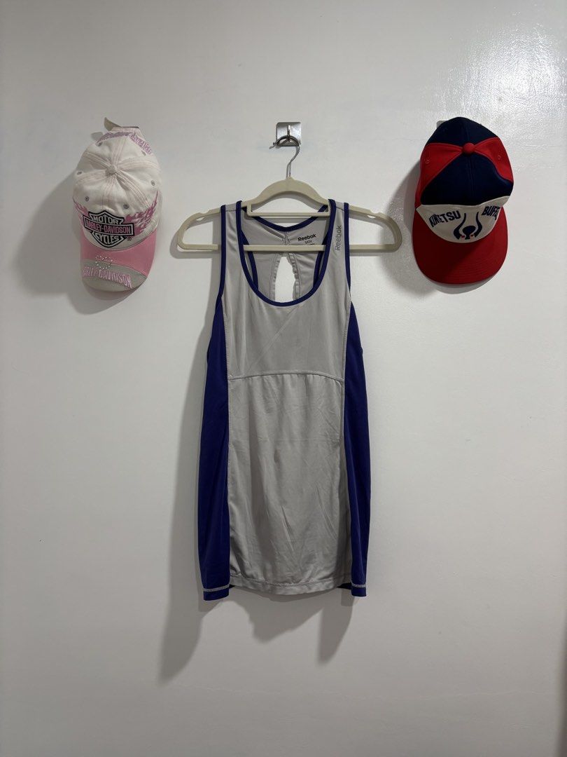 Reebok Workout Tank Top Gray Purple Size S (Category: Activewear) located in Calbayog City. Submitted by zaxcheus_castillo1708 (Listing ID 1469673718, Image 1). Description: - Brand: Reebok - Size: Small (tag shown in photos) - Color: Gray with purple trim and blue side panels - Design: Racerback with stylish back cutout, printed logo on chest - Material: Lightweight athletic fabric - Condition: Excellent, no damage noted - Ideal for: Gym workout