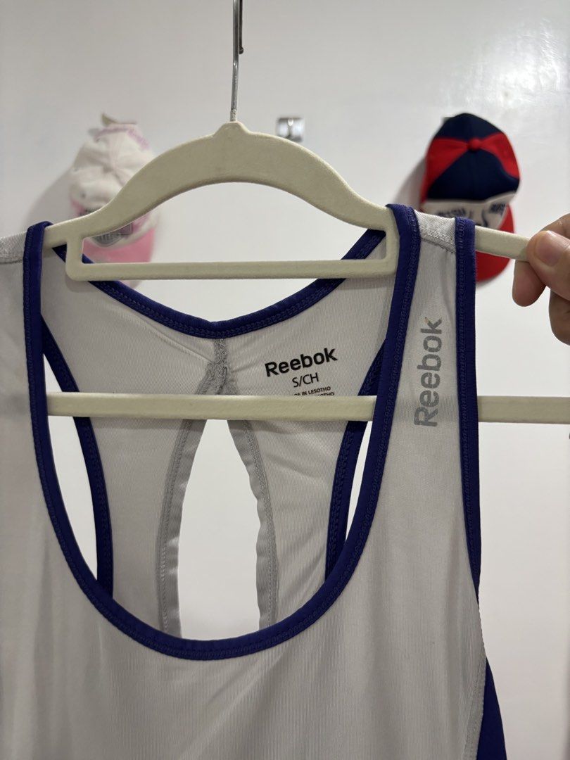 Reebok Workout Tank Top Gray Purple Size S (Category: Activewear) located in Calbayog City. Submitted by zaxcheus_castillo1708 (Listing ID 1469673718, Image 3). Description: - Brand: Reebok - Size: Small (tag shown in photos) - Color: Gray with purple trim and blue side panels - Design: Racerback with stylish back cutout, printed logo on chest - Material: Lightweight athletic fabric - Condition: Excellent, no damage noted - Ideal for: Gym workout