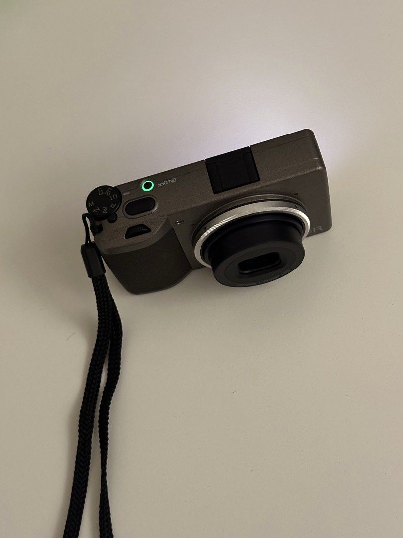 Ricoh GR III Diary Edition (Category: Cameras) located in Cebu City. Submitted by tshamae (Listing ID 1469703320, Image 3). Description: ❗️Ricoh GR III Diary Edition❗️ - very good condition - clean lens - no issues - sc: 6500+ - very pocketable - check all u want Inclusions: - with orig box and the orig inclusions (type c cable, wrist strap, ring caps) - 1 orig battery - 2 durapro batteries - 1 durapro charger - leather case - GR lens cap.