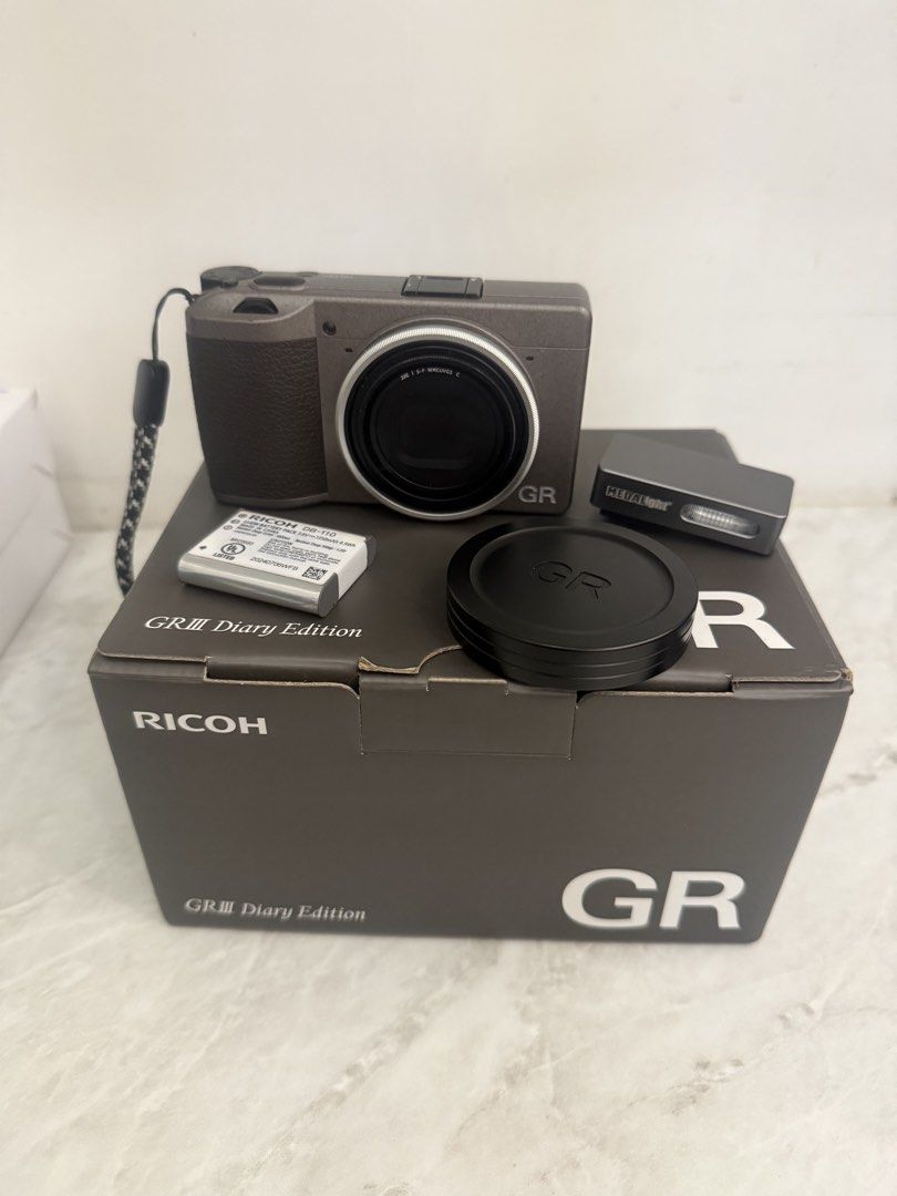 Ricoh GRIII Diary Edition with Freebies (Category: Cameras) located in Manila. Submitted by mackyle (Listing ID 1469659410, Image 1). Description: Model: Ricoh GRIII Diary Edition Type: Compact Digital Camera with latge sensor and fixed prime lens Condition: Fully Functional, Clean Glass, Minimal Body Wear, Minimal Scratches at Hot-shoe Included: Box, Receipt, Black Pouch, Hand Strap, Power Adapter, Charging Cable, Medal Light Mini Flash, Ricoh B