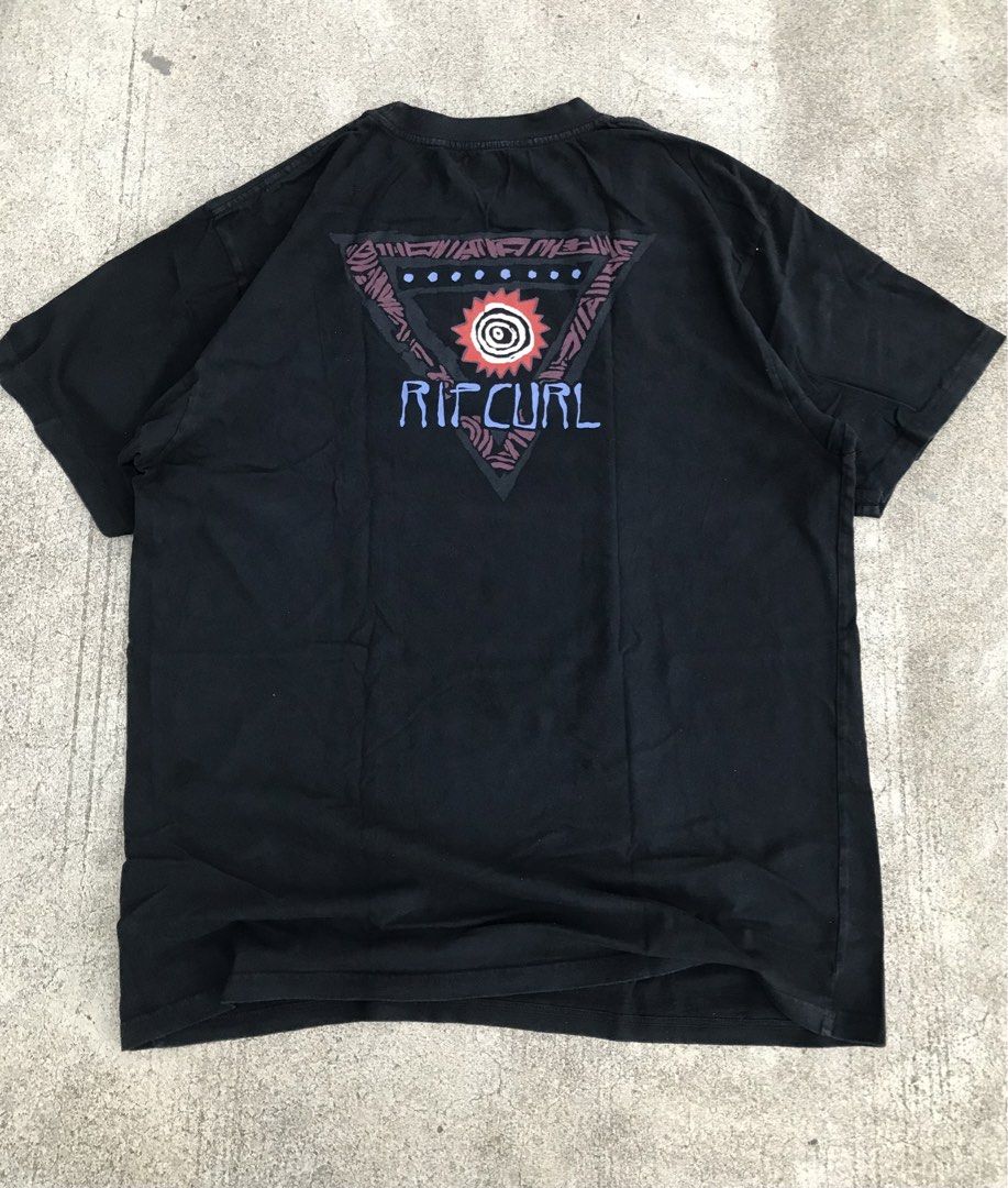 Rip Curl Black Graphic T-Shirt (Category: Tshirts & Polo Shirts ) located in Roxas City. Submitted by rarebear_71a51d (Listing ID 1469704267, Image 2). Description: - Brand: Rip Curl - Color: Classic Black - Design: Small red sun chest graphic, large tribal triangle back print with branding - Fit: Relaxed, comfortable fit - Material: 100% soft cotton - Condition: Excellent / Good as new - Style: Casual, streetwear, everyday wear - Mode of Payment