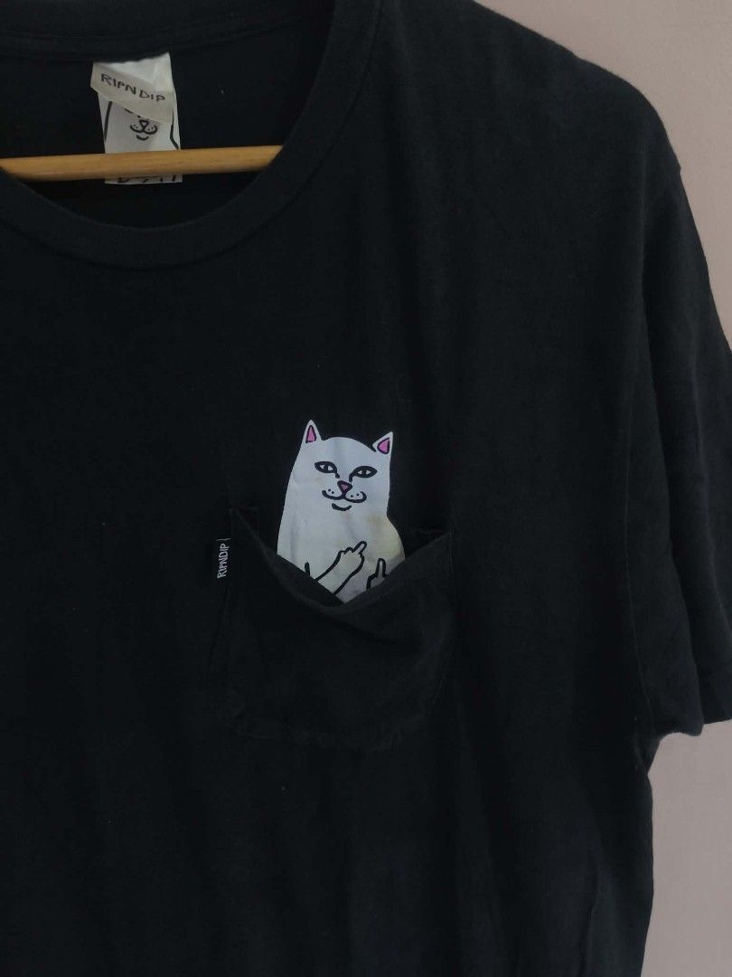 RIPNDIP Lord Nermal Pocket T-Shirt B (Category: Tshirts & Polo Shirts ) located in Manila. Submitted by cookthrift (Listing ID 1469574354, Image 2). Description: - Brand: RIPNDIP - Item: Black pocket t-shirt - Size: Medium - Design: Lord Nermal graphic peeking out of the chest pocket giving the middle finger - Details: Features official RIPNDIP tag on the pocket edge and neck label - Style: Casual streetwear staple with a comfortable fit 20/29.5 