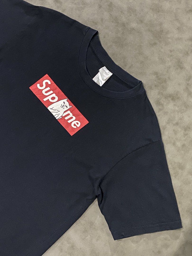 RIPNDIP Supme Black Box Logo T-shirt (Category: Tshirts & Polo Shirts ) located in Rizal. Submitted by dripprojectph (Listing ID 1469650147, Image 2). Description: - Brand: RIPNDIP - Color: Solid Black - Design: Iconic 'Supme' box logo with Lord Nermal cat flipping the bird - Fit: Classic crewneck with short sleeves - Material: 100% Cotton - Condition: Brand new with interior neck tags and wash instructions - Perfect for streetwear and casual wea