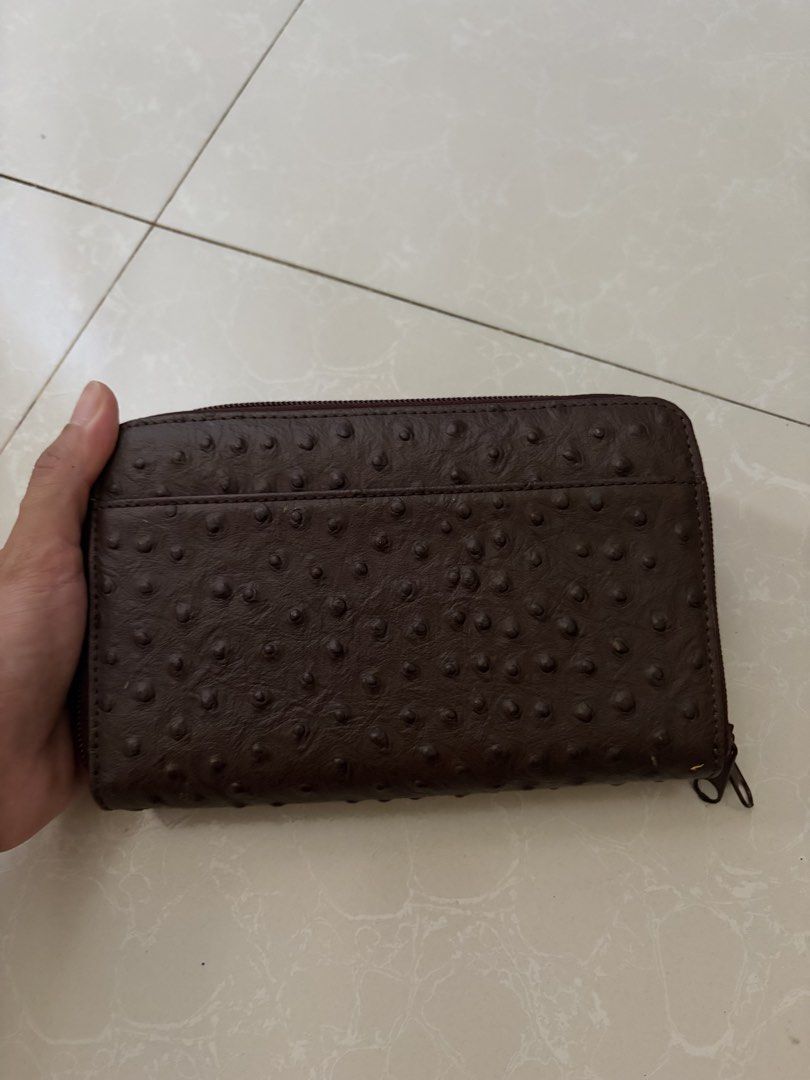 Roberta Viviani Ostrich Leather Wallet (Category: Wallets & Card holders) located in Las Pinas. Submitted by bibliomomma (Listing ID 1469619488, Image 3). Description: Authentic Roberta Viviani long zip-around wallet crafted in rich dark brown ostrich-embossed leather. Features an elegant front flap pocket with gold-tone hardware and the signature “R” emblem. The spacious interior includes multiple card slots, bill compartments, and a central zip
