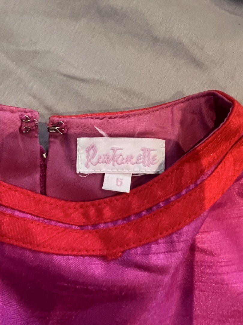 Rustanette Pink Dress Size 5 (Category: Babies & Kids Fashion) located in Manila. Submitted by asecondstory (Listing ID 1469584249, Image 3). Description: - Brand: Rustanette - Size: 5 - Color: Bright pink with red trim details - Features: Attached red waist tie, short sleeves, flared pleated skirt, and back zipper closure - Condition: Clean interior lining with visible brand and size tags.