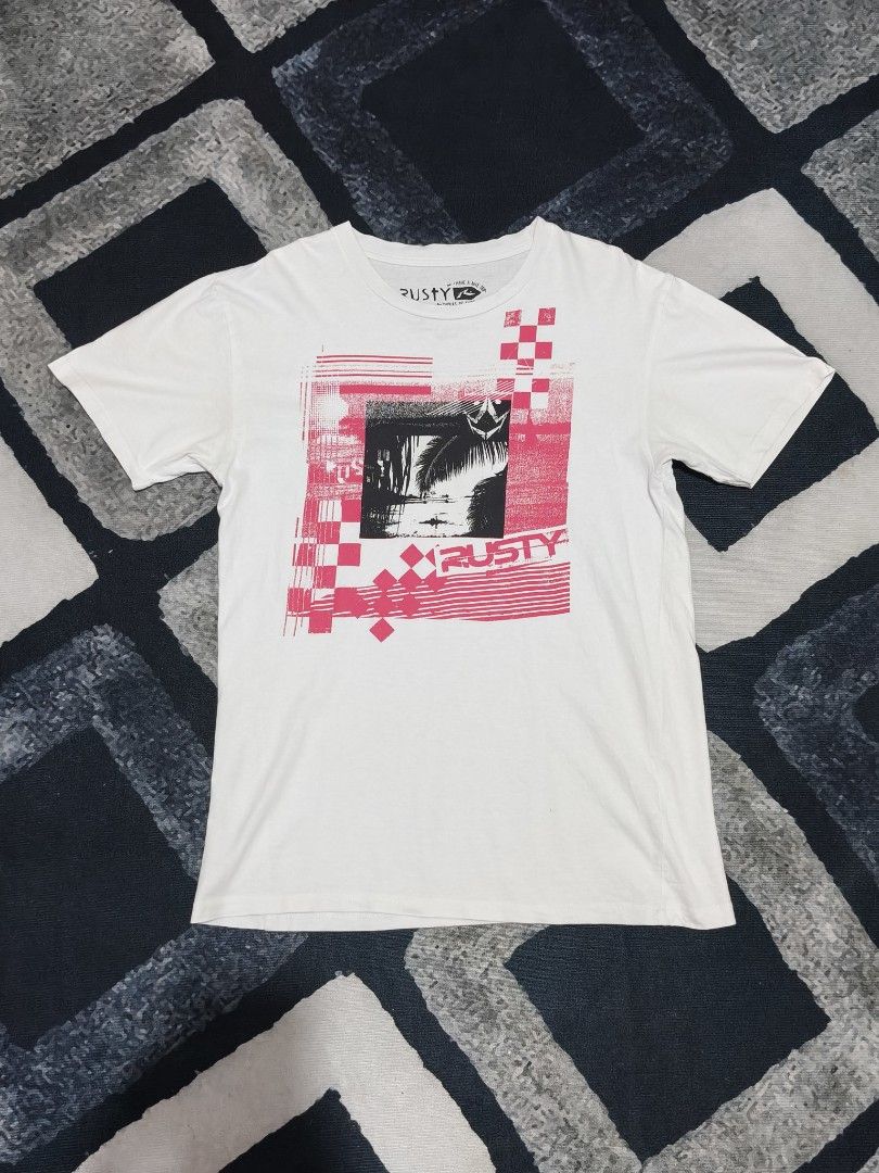Rusty White Graphic Tee Surf Skate Streetwear (Category: Tshirts & Polo Shirts ) located in Andop. Submitted by kyutoryuu (Listing ID 1469582014, Image 1). Description: Rusty Graphic Tee •Dimes: 19x27 •Condition: Excellent •CR: 9.5/10 •Issue: need rewash.