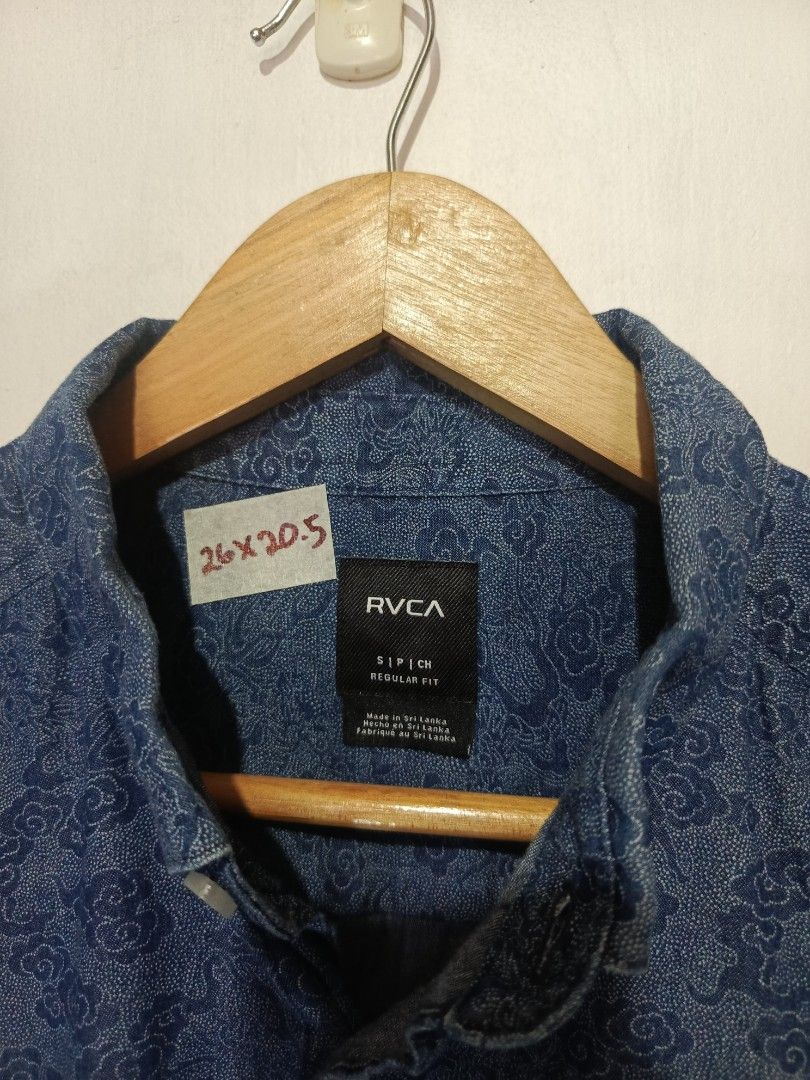 RVCA BUTTON DOWN PATTERN SHORT SLEEVE (Category: Tshirts & Polo Shirts ) located in Baguio. Submitted by 074thriftmania (Listing ID 1469692433, Image 3). Description: - Brand: RVCA - Style: Short sleeve button-down shirt - Fit: Regular fit - Design: All-over intricate pattern with button-down collar and front chest pocket featuring a small brand tag - Origin: Made in Sri Lanka - Measurements: 26" length x 20.5" width (tagged on collar tape) - Con